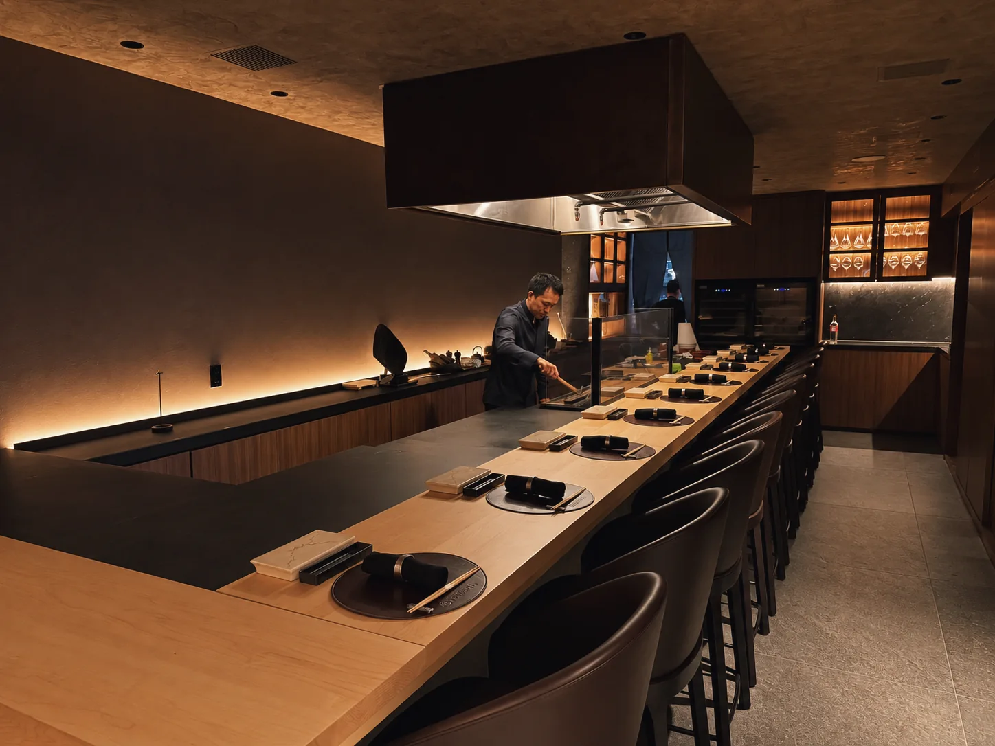 Chef grilling at Momiji’s intimate wooden yakitori counter
