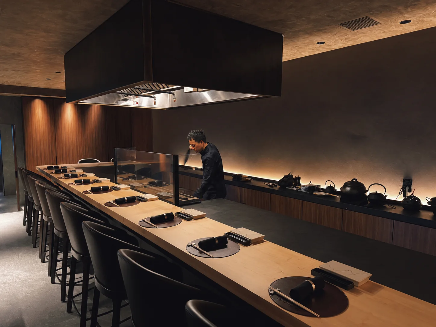 Twelve counter seats surrounding the chef and charcoal grill